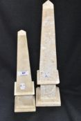 Two stone cut obolisk one being marble and similar larger lime stone example, both being repaired.