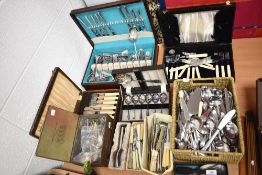 A large assortment of cutlery, flatware and serving items.