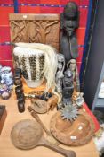 A selection of Ethnic tribal items including carved wooden figures, candlesticks, drum and wall