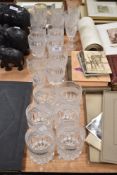 A suit of cut glass including tumblers, champagne glasses and wine glasses.
