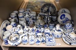 A large collection of modern Dutch delft wares including model windmills, Dutch clogs, tankards