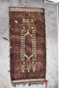 A 20th century Persian Afghan Balouch saddle bag in woven wool in a brown and red ground