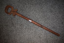 A 20th century African walking stick of plain design with hoop handle.
