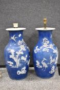 A pair of antique Qing dynasty mirrored floor vase having a reverse blue and white embossed