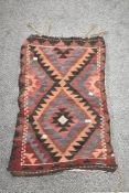 A 20th century Persian Afghan Balouch saddle bag in woven wool in a blue purple and red ground