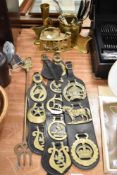 Three horse brass straps, a pair of swan design book ends, a brass stove iron and some cutlery.