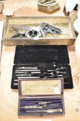 An Engineers marking and measuring level and set square with two geometry sets.