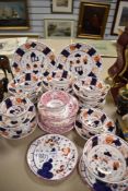 A selection of tea cups and saucers with cake plates in Gaudy Welsh and Sunderland lustre patterns