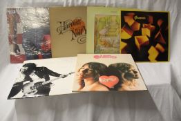 A mixed lot of twelve albums from Neil Young, SAHB. Springsteen, Genesis, Heart and Queen