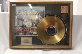 A Beatles framed gold disc decorative piece of wall art