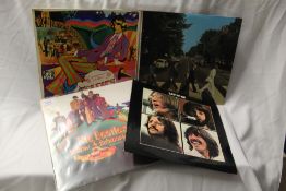 A lot of four original UK Beatles albums including the Portuguese press of Yellow Submarime which