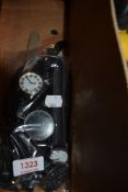 Ten mens watches all having black straps.