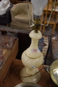 A turned alabaster table lamp, with gilt embellishments, lacking shade