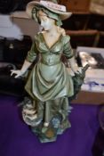 A Victorian German porcelain figure of a fish seller having a Royal Dux style glaze with slight