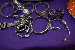 10 wrist watches all in silver tones.