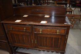 An early 20th Century oak sideboard on twist legs
