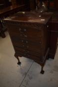 A late 19th or early 20th Century mahogany chest of six typical drop front drawers, having ball