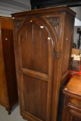 An early 20th Century oak hall robe or wardrobe in the Gothic design with carved rosette decoration,