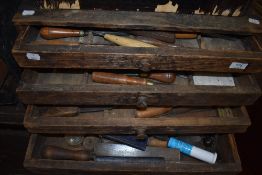 A vintage tool chest containing woodworking chisels and carving tools etc