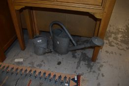 Two vintage galvanised watering cans