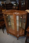 A mid 20th Century walnut china display cabinet
