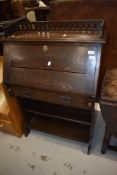 A Victorian oak bureau in the Arts and Crafts style with bookshelf under