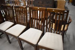 A set of four modern stained frame rail back dining chairs