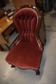 A Victorian balloon back low seat easy chair