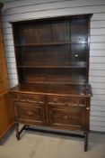 A late 19th or early 20th century oak dresser having cushioned drawers and twist leg frame