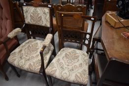 An Edwardian mahogany and inlaid salon armchair and similar dining chair