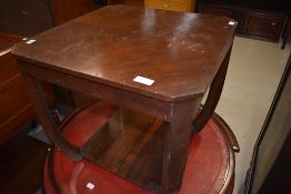 A vintage mahogany or walnut dark stained occasional table of stylised design