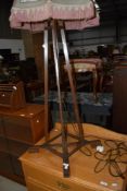 An early 20th Century oak framed standard lamp , of interesting design with adjustable height