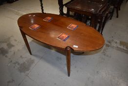 A vintage oval coffee table of stylised design