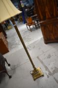 A reproduction brass effect standard lamp