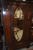 An early 20th Century oak mirror door wardrobe