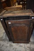 A period oak cabinet having panelled door