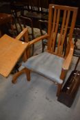 A Peter Hall and son of Staveley bespoke golden oak arm chair or carver with a retractable reading