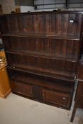 A set of Edwardian mahogany bookshelves, having double cupboard to base with inlay decoration, width