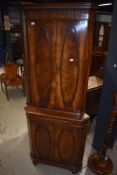 A reproduction Regency style corner cabinet