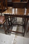 An early 20th Century oak occasional table having twist leg frame