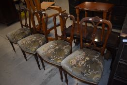 A set of four Victorian mahogany salon chairs having later upholstery