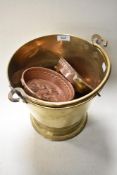 A mixed lot of vintage copper and brass, to include Heavy brass bucket and copper food moulds.