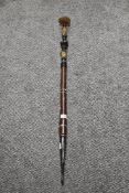 An antique opium pipe having wood shaft and horn banding.