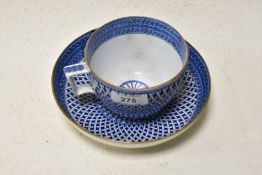 An early 19th century breakfast cup and saucer having tin glaze with basket weave transfer pattern.