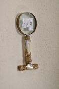 A Rolled gold and MOP handled magnifying glass, marked 18PG and monogrammed with A.M.L, possibly