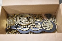 a box of mixed horse brasses and Martingale.