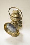 An antique brass Brown Brothers Veena oil coach lamp with handle and convex glass door.