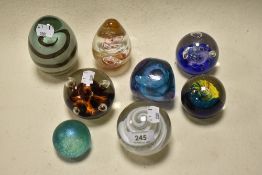 Nine paper weights of varying style and colour, including Heron glass and Caithness.