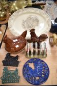 A collection of hen interest kitchen ware, trivets, egg dish, toast rack etc, also included is a