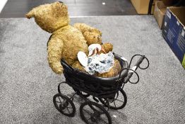 An antique style wood and wicker dolls pram, two well loved vintage teddies and a small porcelain